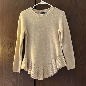 Cliche cream colored long sleeved sweater with ruffle at the bottom. MP